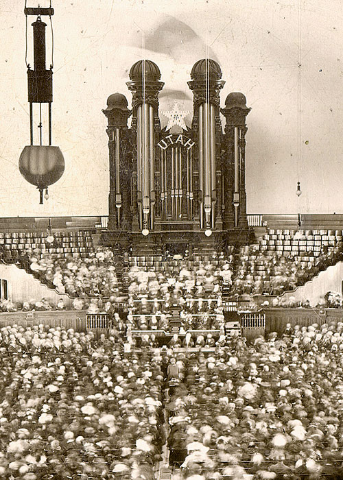 Photograph of the October 1897 General Conference in the Salt Lake Tabernacle. The congregation fills the hall beneath the grand Tabernacle organ marked “UTAH,” celebrating the state’s recent admission to the United States the year before.