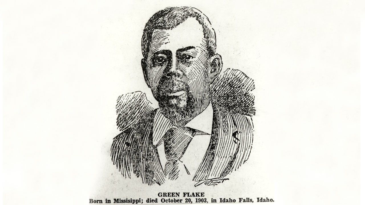 A black-and-white ink drawing of Green Flake. He is depicted wearing a suit with a collared shirt and tie, with short hair and a beard. The illustration uses fine lines to create shading and texture. Below the image, text states: “Green Flake. Born in Mississippi; died October 20, 1903, in Idaho Falls, Idaho.”