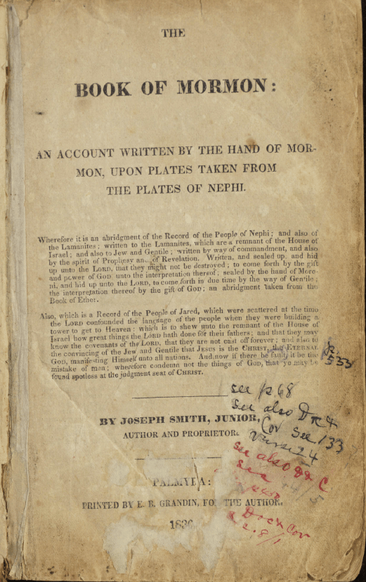 The title page of B. H. Roberts's personal copy of the 1830 first edition of the Book of Mormon. The page reads "The Book of Mormon: An Account Written by the Hand of Mormon, Upon Plates Taken from the Plates of Nephi" and includes publication information from Palmyra, printed by E. B. Grandin. Numerous handwritten annotations in blue, black, and red ink appear in the margins and lower half of the page, referencing scriptures and page numbers, reflecting Roberts's study and analysis of the text.